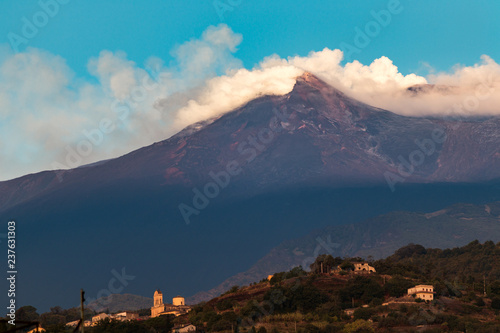 Toxic gas clouds rising from the new south east crater of mount Etna at sunrise. Sant'Antonino, Sicily, Italy. © fnendzig