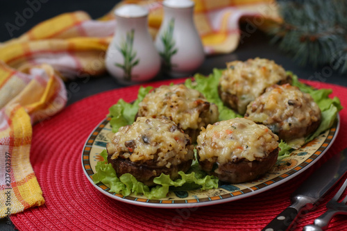Stuffed champignons with mozzarella cheese, vegetables and bulgur, appetizer on a festive table, close up, horizontal