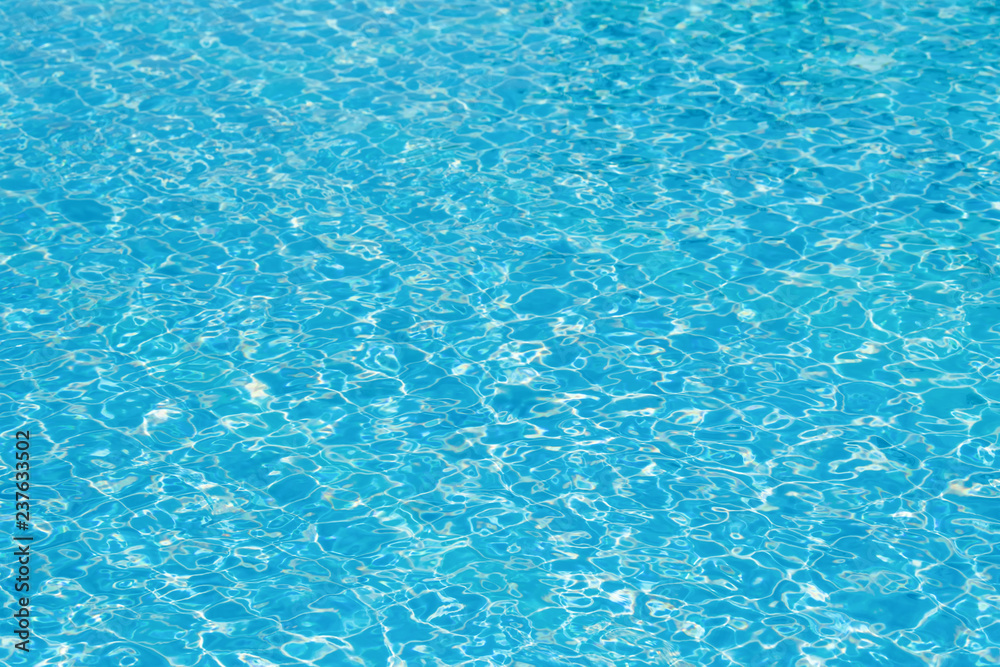 Bright and blue water surface in swimming pool with sunlight, Ripple water in pool