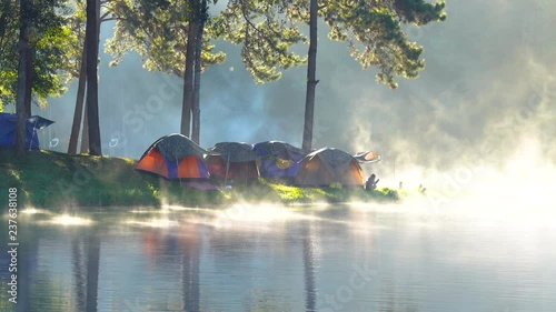 Adventures Camping tourism and tent under the pine forest with reflection on water  in morning at Pang-ung, Mae Hong Son, Thailand