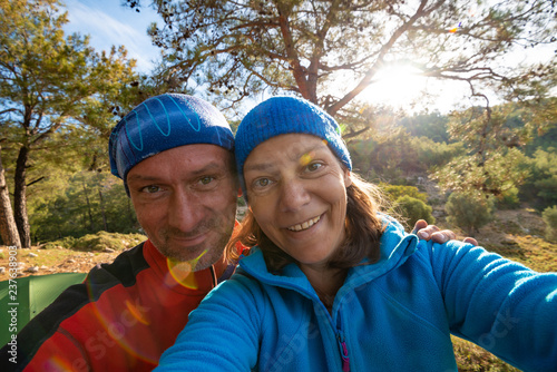 Couple of happy travelers taking selfie in the mountains