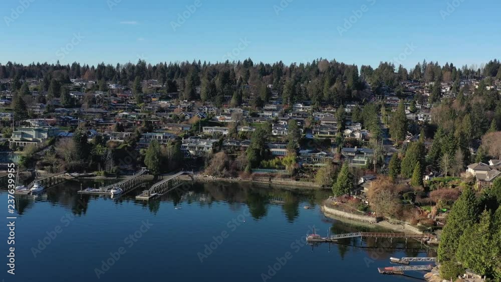 Aerial view over Burrard Inlet, ocean and island with boat and mountains in beautiful British Columbia. Canada. Aerial view over Burrard Inlet, ocean and island with boat and mountains in beautiful British Columbia. Canada.