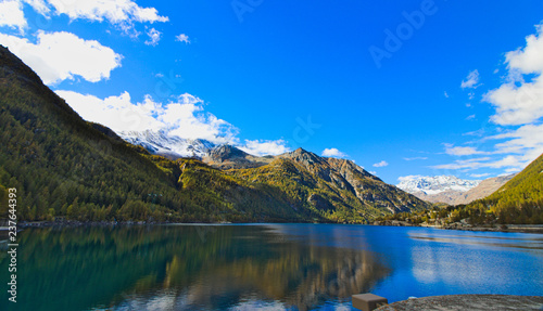 Fototapeta Naklejka Na Ścianę i Meble -  Lake of Ceresole Reale, near the Nivolet pass, clear autumn morning, blue sky, Piedmont, Italy