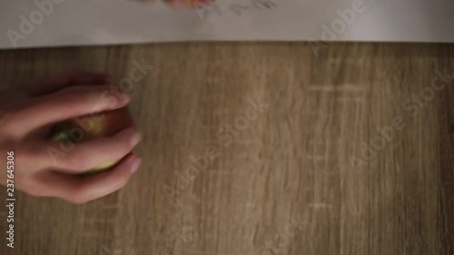 Hands of people different races takes beautiful apples from the the wooden table close up photo