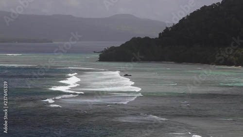 Waves head towards Qamea Island shore, wide photo