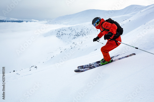 A boy is skiing fast down the hill