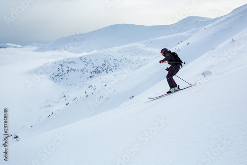 A girl is skiing fast down the hill in Carpathian mountains.