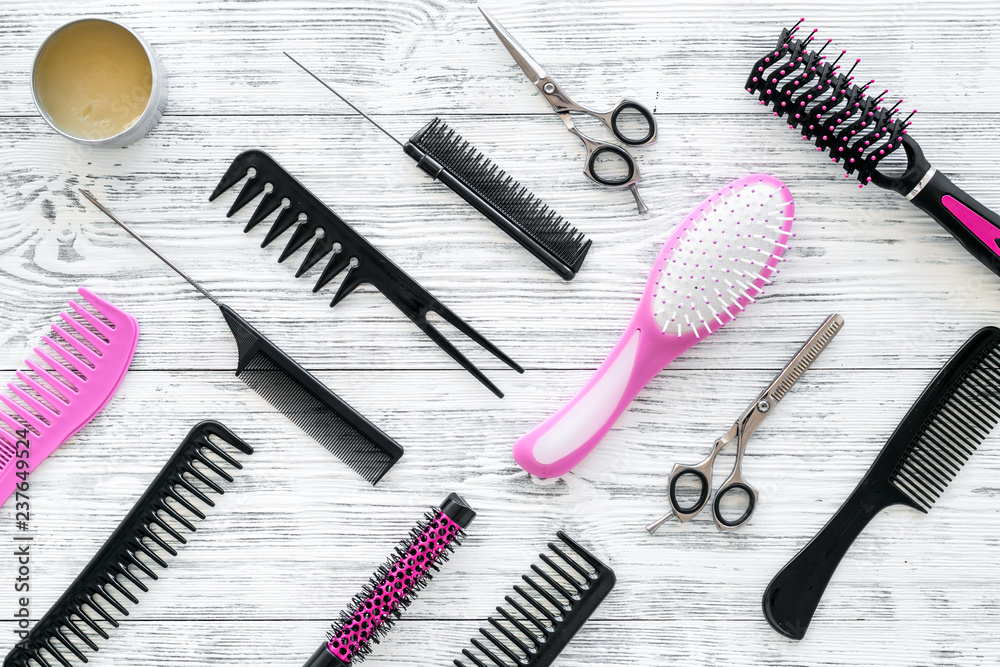 female hairdresser desk with accessories and combs on white wooden background top view female hairdresser desk with accessories and combs on white wooden background top view