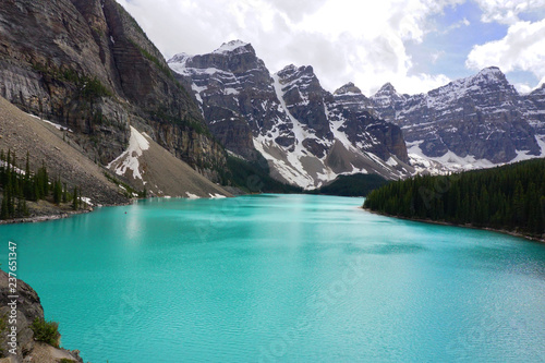 The Moraine lake with snow-covered rocky mountains in Banff National Park of Canada.
