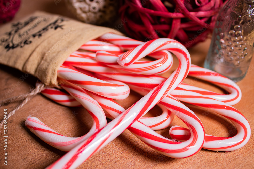 red and white candy canes on wood table