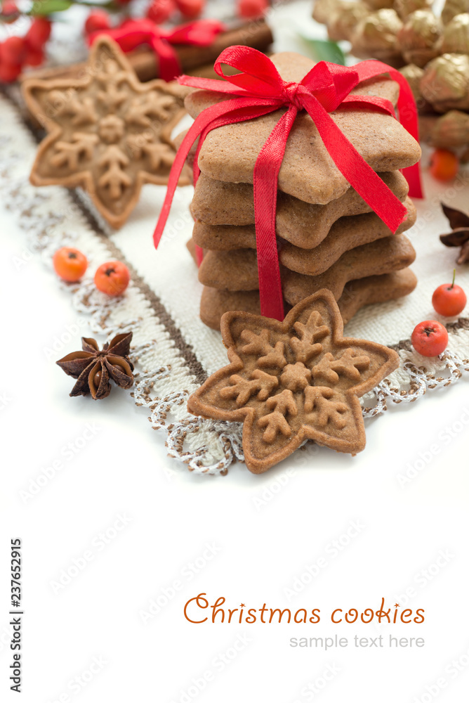 Element of Christmas decoration on the napkin for your design. Christmas cookies, gingerbread handmade in the shape of stars with red ribbon. Top view