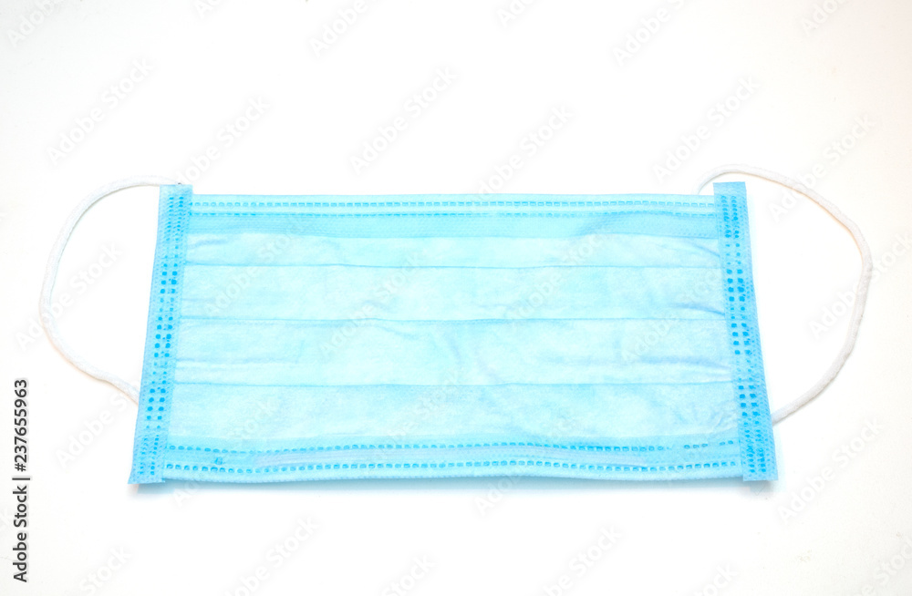 Fototapeta premium close-up of disposable blue medical face mask on white background