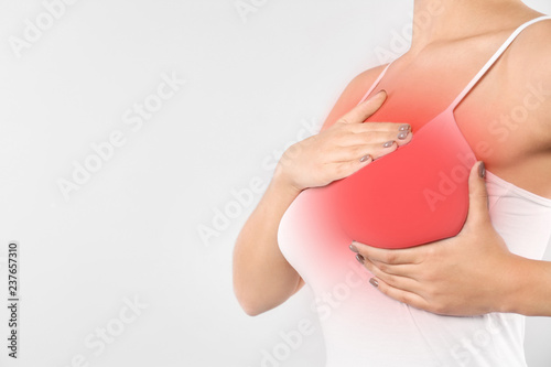 Wallpaper Mural Woman doing breast self-examination on light background, space for text. Cancer awareness Torontodigital.ca