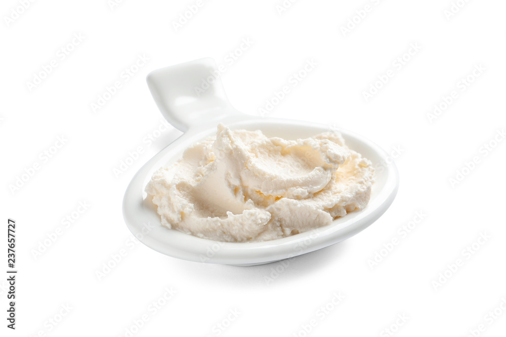 Serving spoon with tasty cream cheese on white background Serving spoon with tasty cream cheese on white background