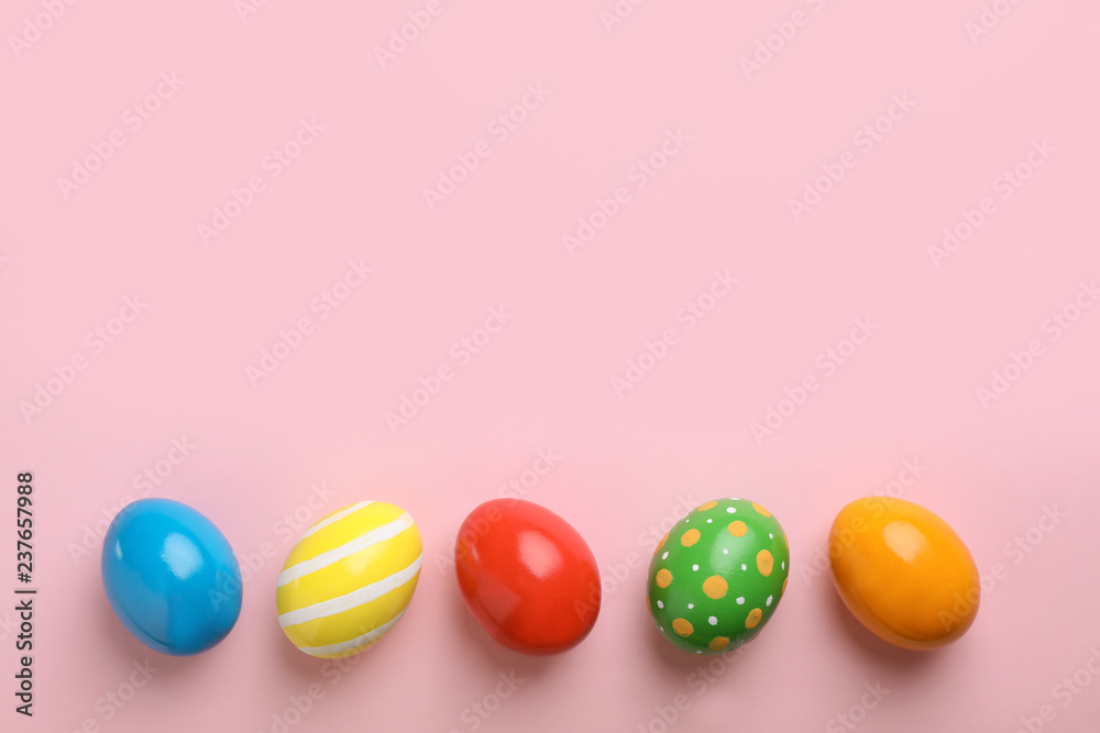 Decorated Easter eggs and space for text on color background, top view