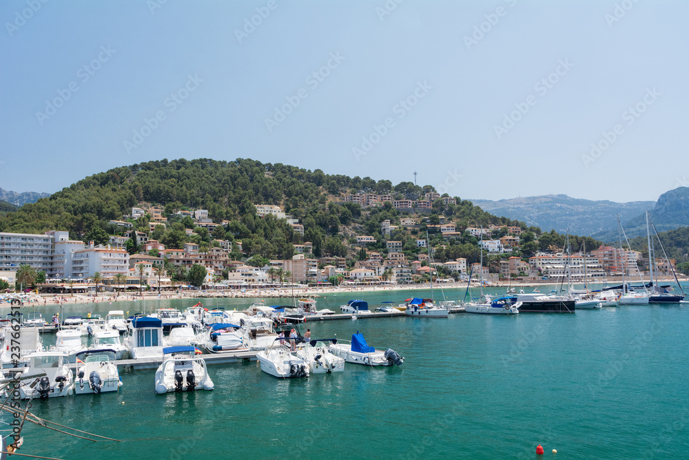 Port de Soller, Mallorca, Spain - July 19, 2013: View from the sea of the city, yachts, beach, streets, hotels.