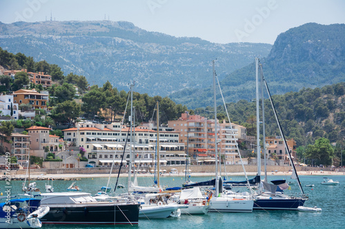 Port de Soller, Mallorca, Spain - July 19, 2013: View from the sea of the city, yachts, beach, streets, hotels.