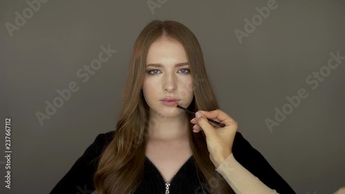 Model girl in front of the camera put makeup photo