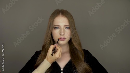 Model girl in front of the camera put makeup photo