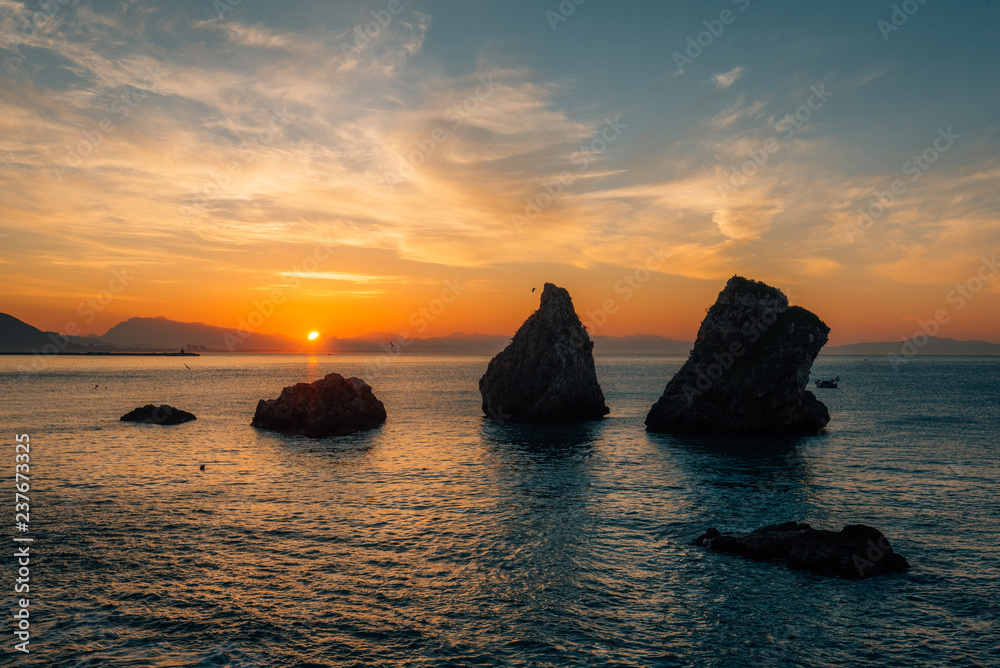 Sunrise over rocks in the Gulf of Salerno, in Vietri sul Mare, Amalfi Coast, Italy.
