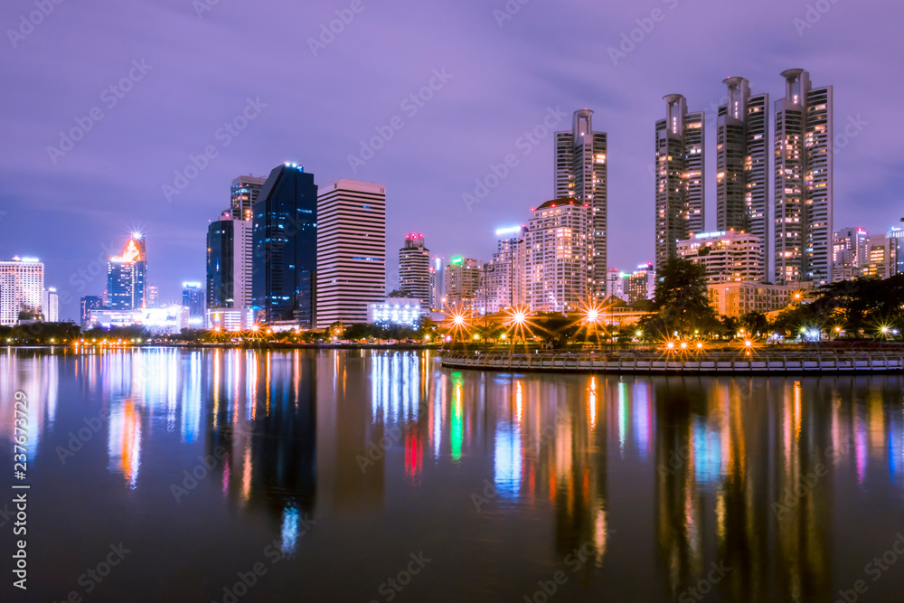 Bangkok, Thailand - December 5, 2017 : benjakiti park Landscape building at night reflects the beautiful pond