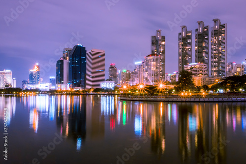 Bangkok, Thailand - December 5, 2017 : benjakiti park Landscape building at night reflects the beautiful pond © Small fish