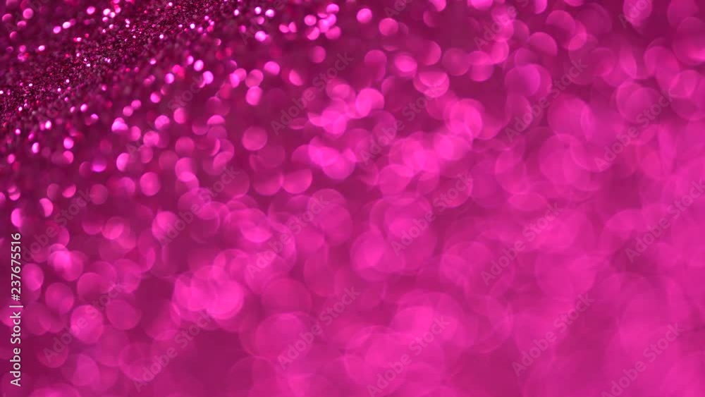 Shiny magenta surface rotates. Magic bokeh background