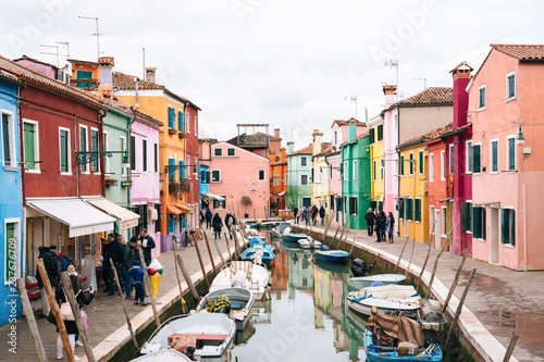 Colorful buildings along a canal in Burano, Venice, Italy © jonbilous