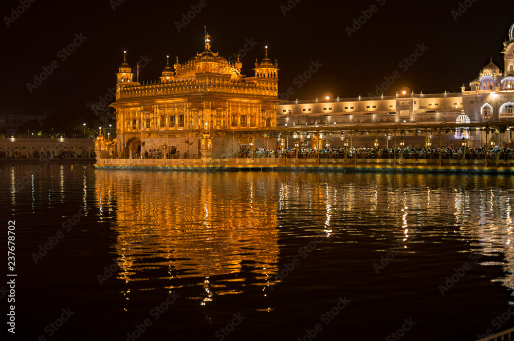 Golden temple illuminated with electric lights turned