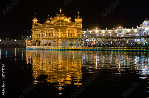 Colorful and illuminated golden temple and its reflection © ProMicroStockRAW