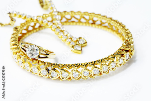 Gold jewelry on white background.