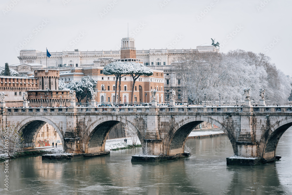 Ponte Sant'Angelo and the Tiber River in the snow, in Rome, Italy