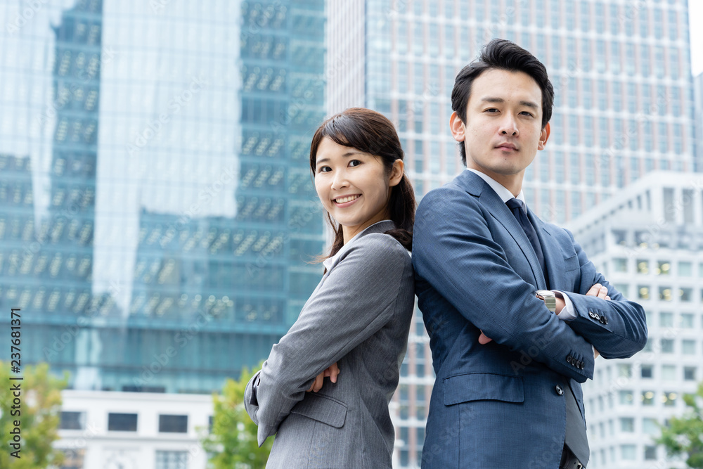 portrait of young asian business person standing in
front of building portrait of young asian business person standing in
front of building