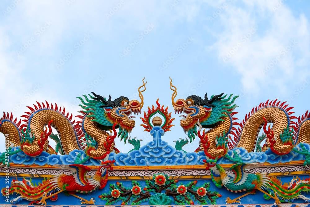 Dragons and swans in Chinese art adorn arches of entrance to the shrine