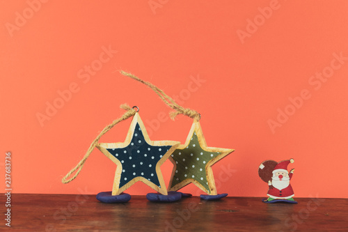 Toy Santas on wood and paper background