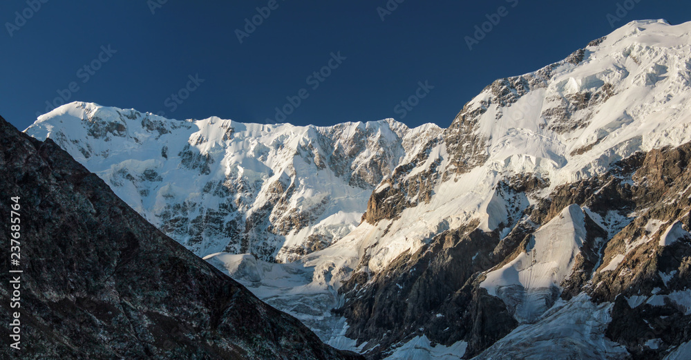Panoramic view of the beshengi wall. Steep walls covered with ice and snow at sunrise.