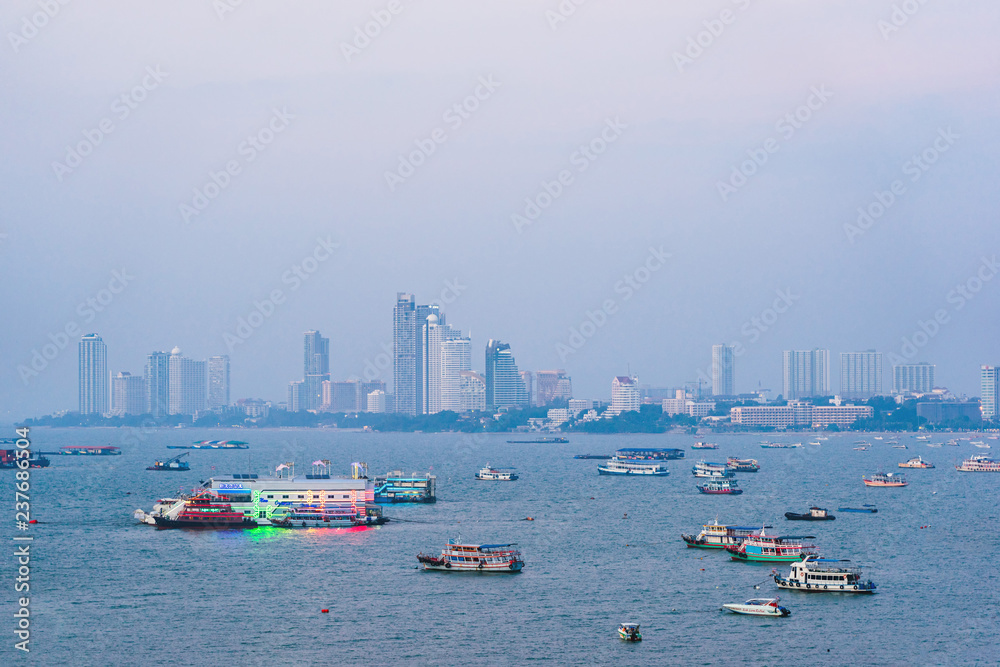 Boats and ships in Pattaya bay with city background