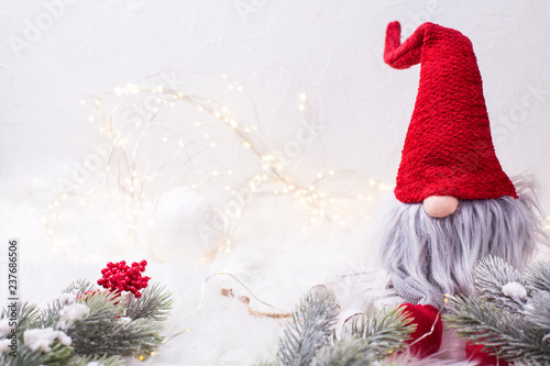 Obraz na plátně Decorative christmas elf or gnome with fairy lights, ball  and fir tree branches