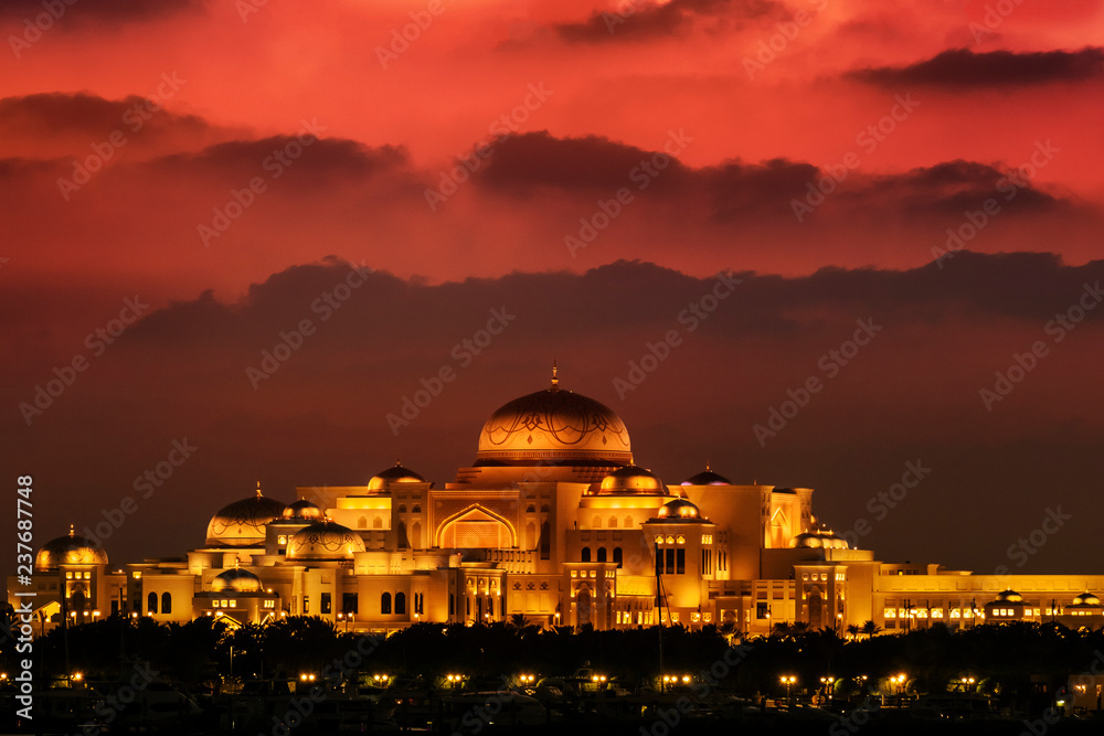 Beautiful sunset over the uae presidential palace in Abu Dhabi. The clouds look like mountains in the background.