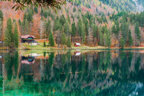 Fototapeta Naklejka Na Ścianę i Meble -  Autumn sunrise on the lower lake of Fusine. Explosion of colors