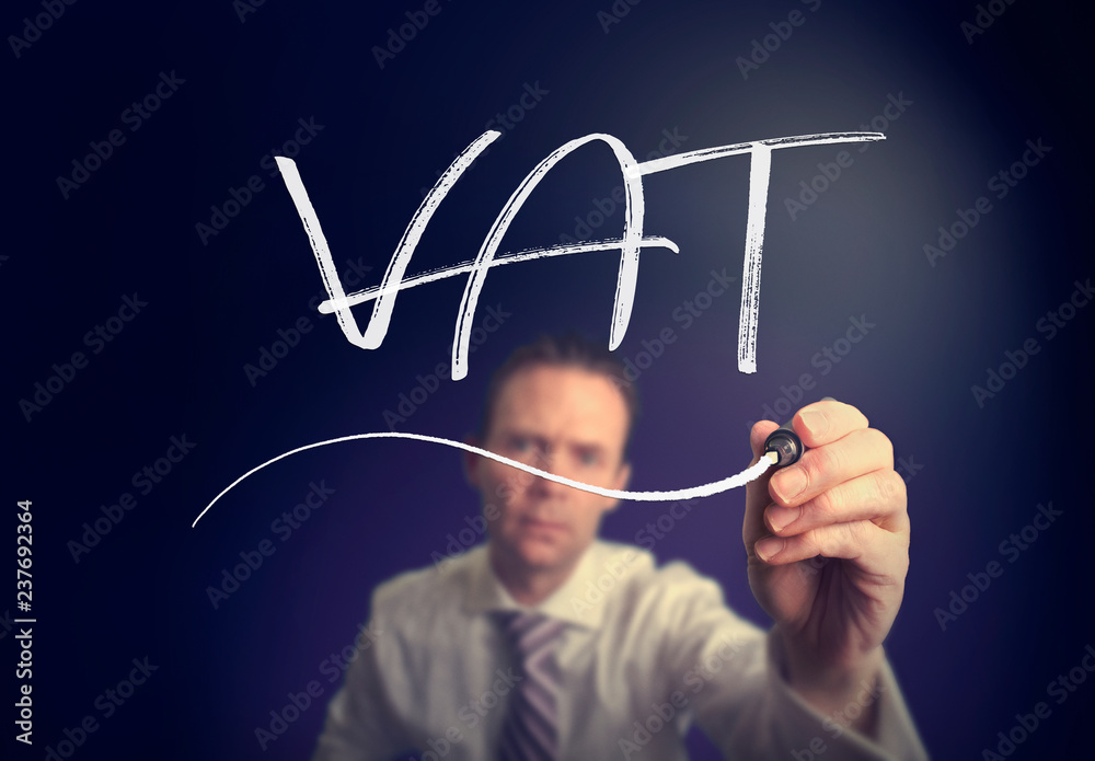 A businessman writing a VAT concept with a white pen on a clear screen. A businessman writing a VAT concept with a white pen on a clear screen.