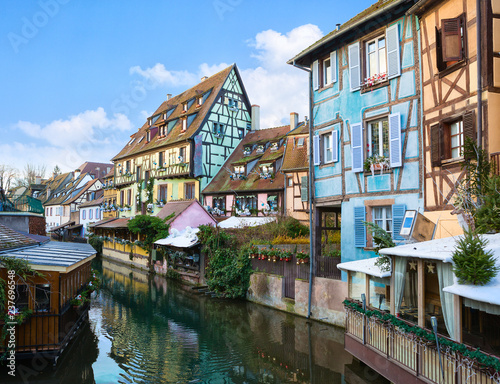 Picturesque old tourist area near  the  historic center of Colmar, Haut-Rhin,  Alsace, France. Traditional old houses decorated for Christmas on the canal. photo