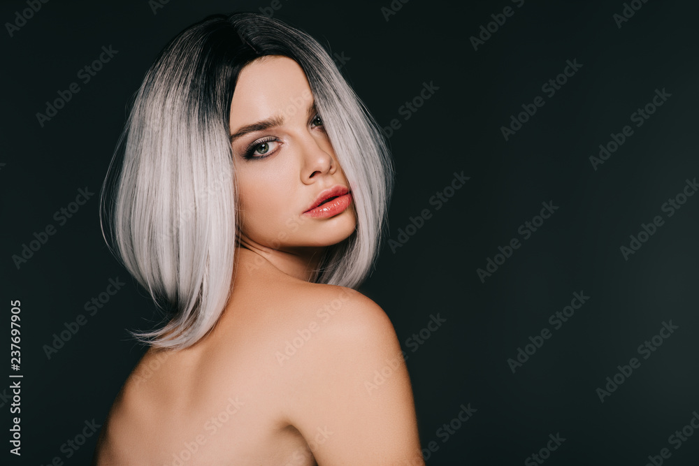 beautiful stylish young woman posing in grey wig, isolated on black beautiful stylish young woman posing in grey wig, isolated on black