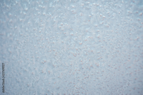 The patterns made by the frost on the window. Frosty winter background photo