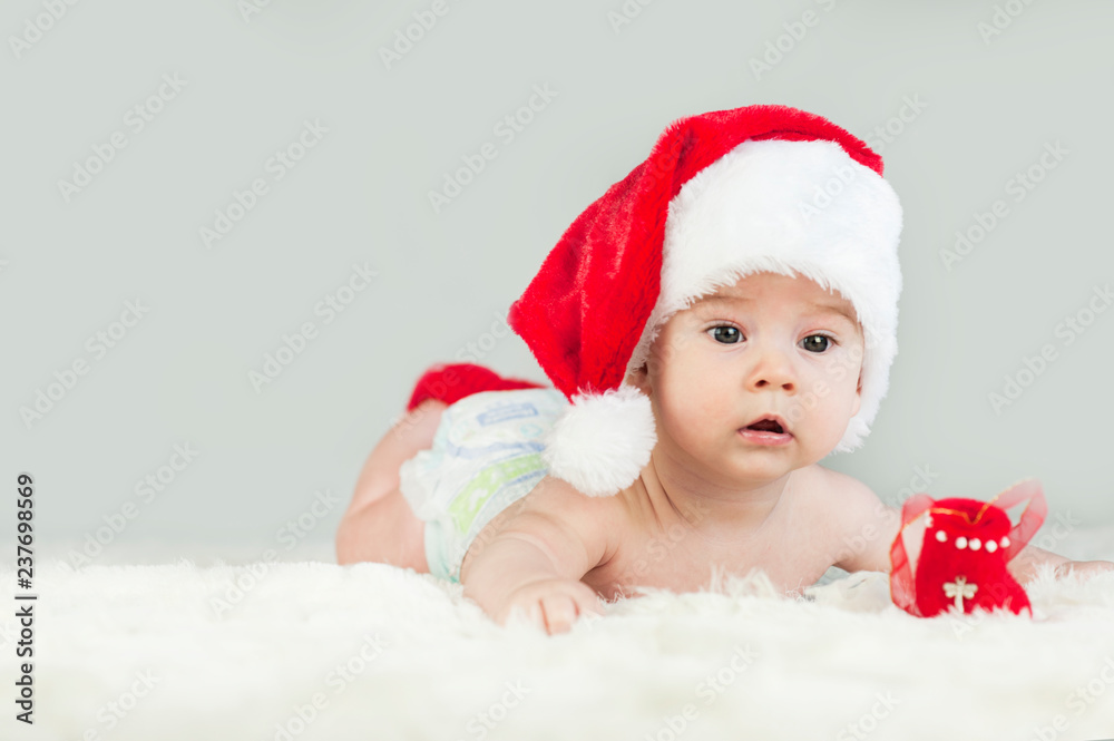 Happy newborn girl in santa hat. New Year,Christmas Happy newborn girl in santa hat. New Year,Christmas