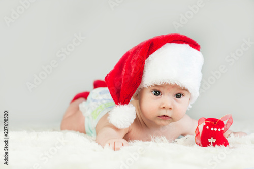 Happy newborn girl in santa hat. New Year,Christmas