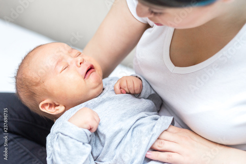 newborn is crying because of colic pain photo