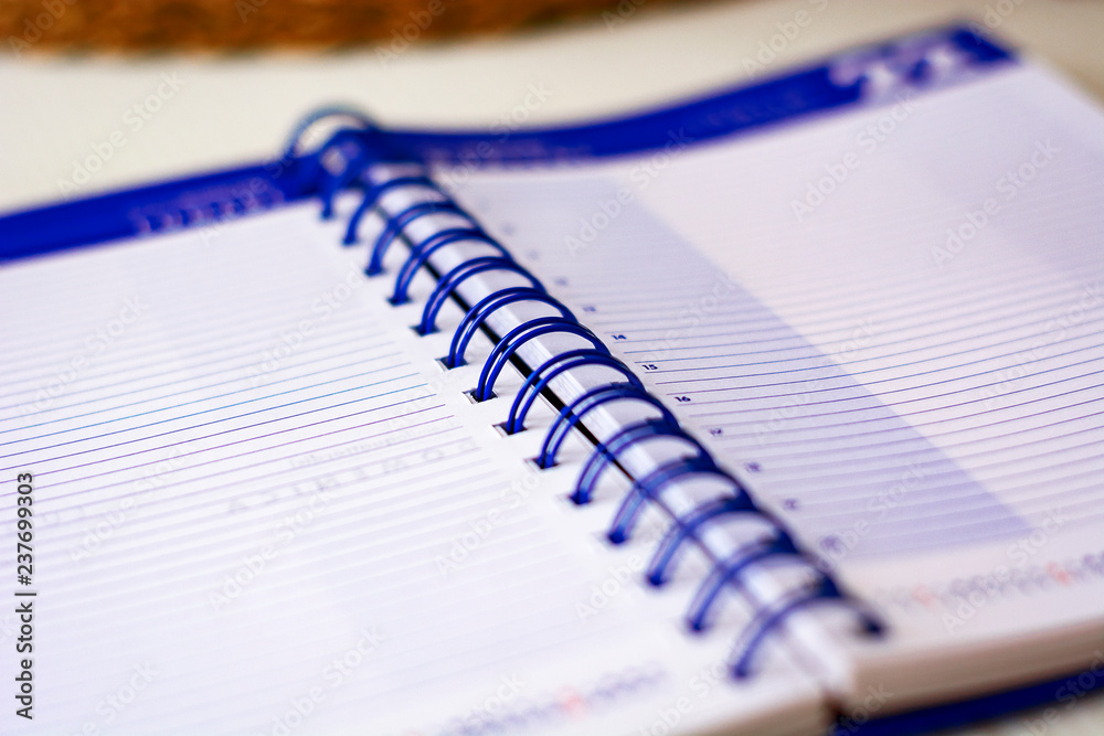 Open spiral notebook with lined sheets to write important appointments of the day Open spiral notebook with lined sheets to write important appointments of the day