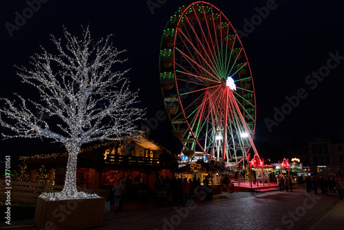 Ferris wheel and tree in lots of light at the christmas fair in 