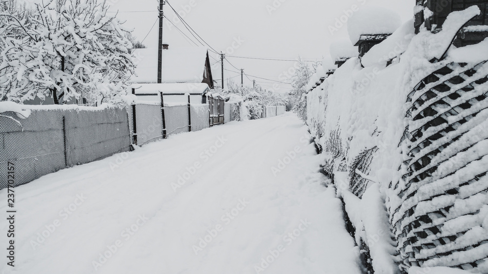 Obraz premium Magic fairy tale Only crumbly snow fell. Street and fences in the snow. All white